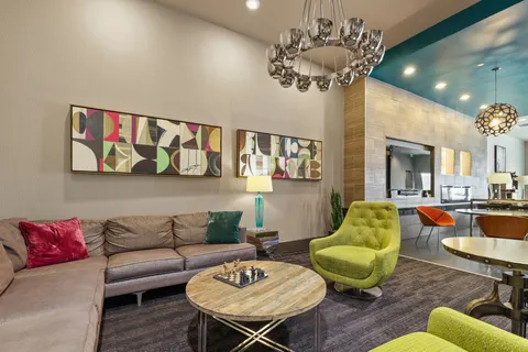 a living room with furniture and a chandelier