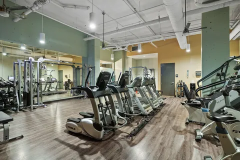 a view of a patio with table and chairs with wooden floor and fence