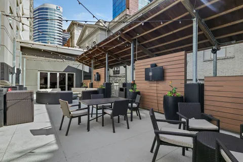 a view of a livingroom with furniture staircase and a window