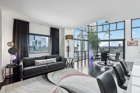 a living room with furniture and a large window