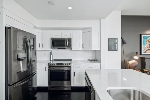 a kitchen with a sink stainless steel appliances and cabinets