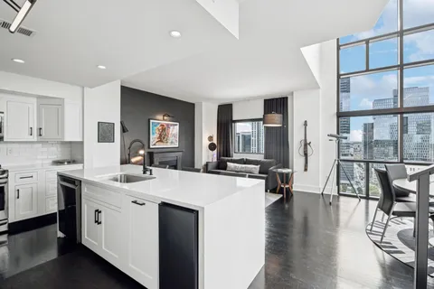 a large white kitchen with a large window