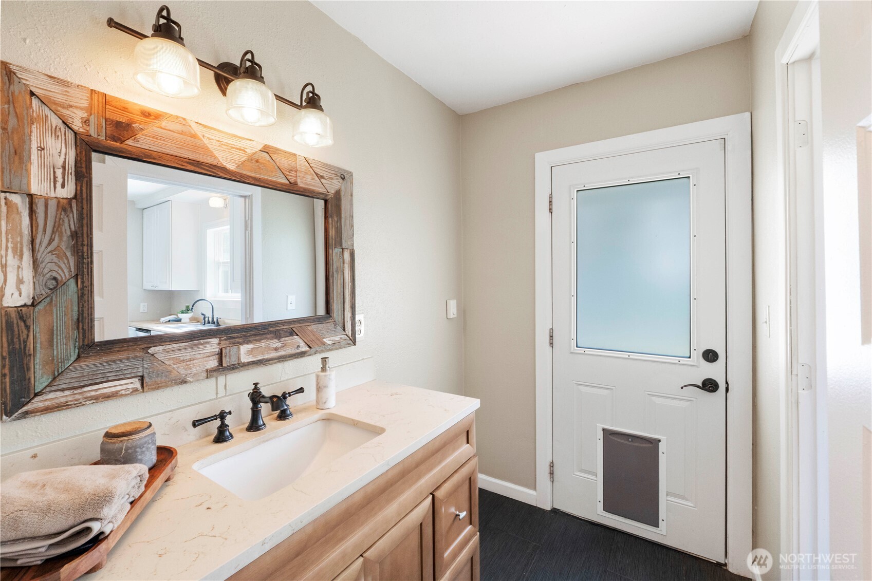 11716 48th Street East Edgewood, WA 98372 - Photo 11 of 29 a bathroom with a sink vanity and a mirror