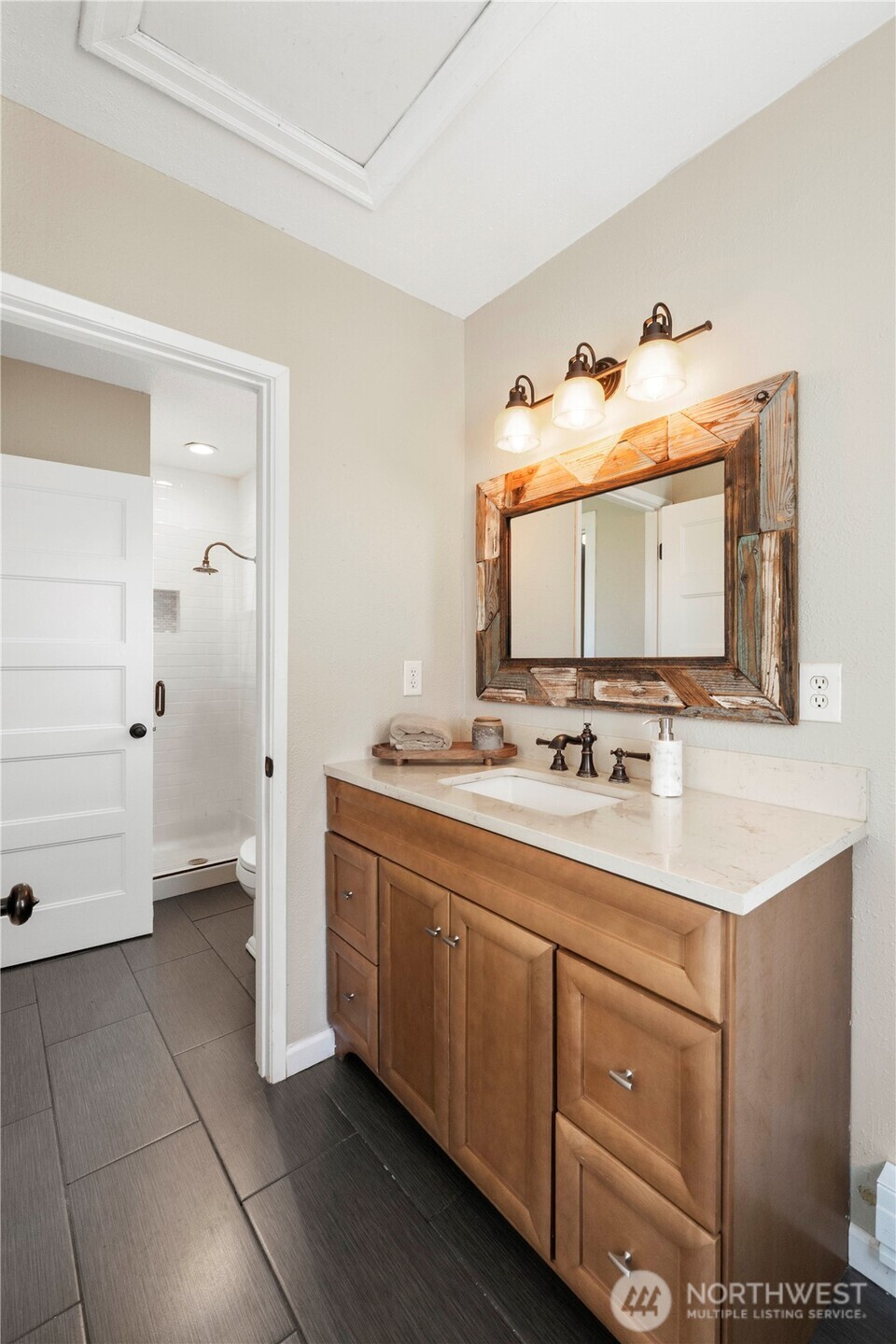 11716 48th Street East Edgewood, WA 98372 - Photo 12 of 29 a bathroom with a sink and a mirror