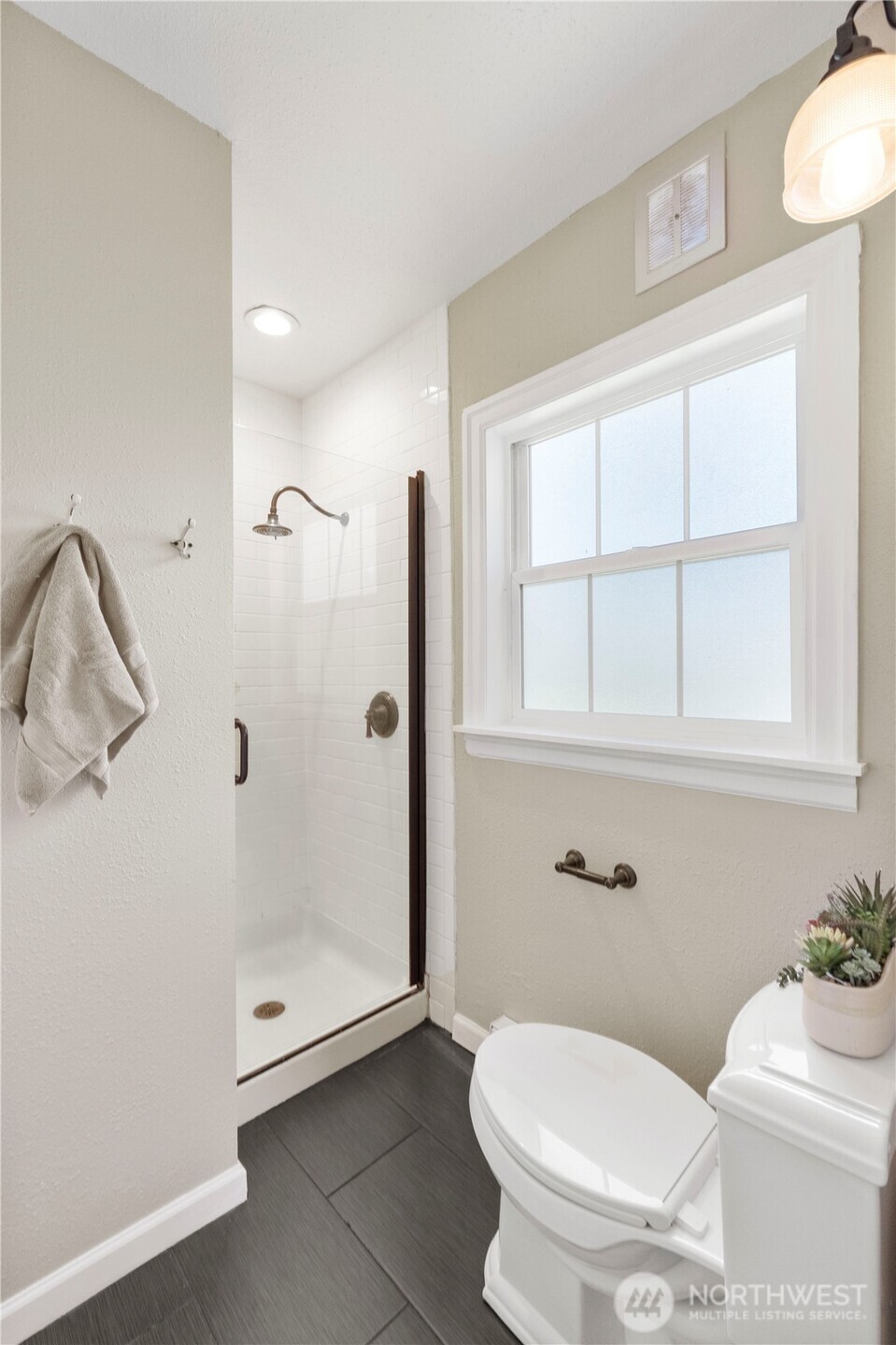 11716 48th Street East Edgewood, WA 98372 - Photo 13 of 29 a bathroom with a toilet and a shower