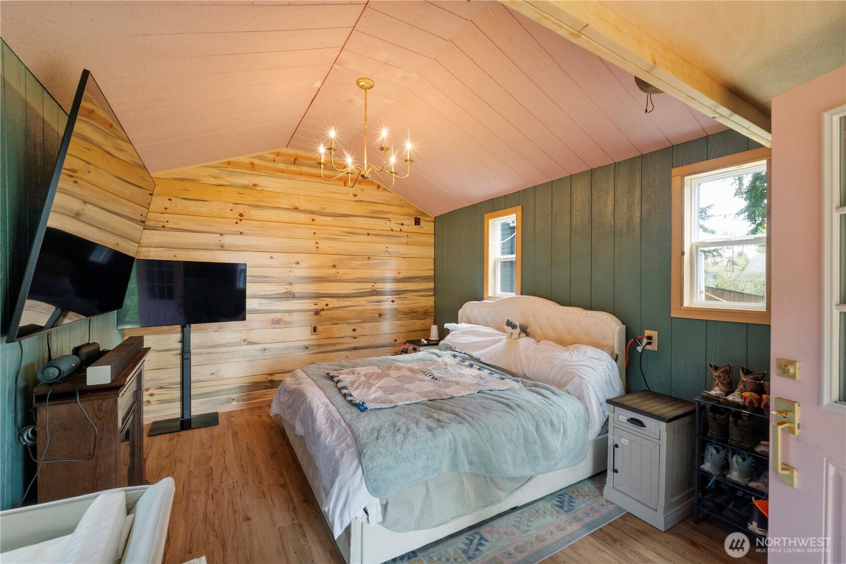 11716 48th Street East Edgewood, WA 98372 - Photo 16 of 29 a spacious bedroom with a bed and a flat tv screen