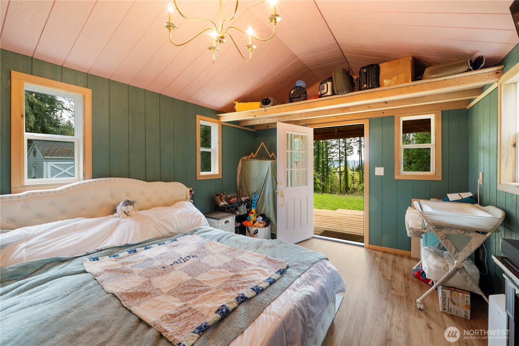11716 48th Street East Edgewood, WA 98372 - Photo 17 of 29 a bedroom with a bed and a chandelier