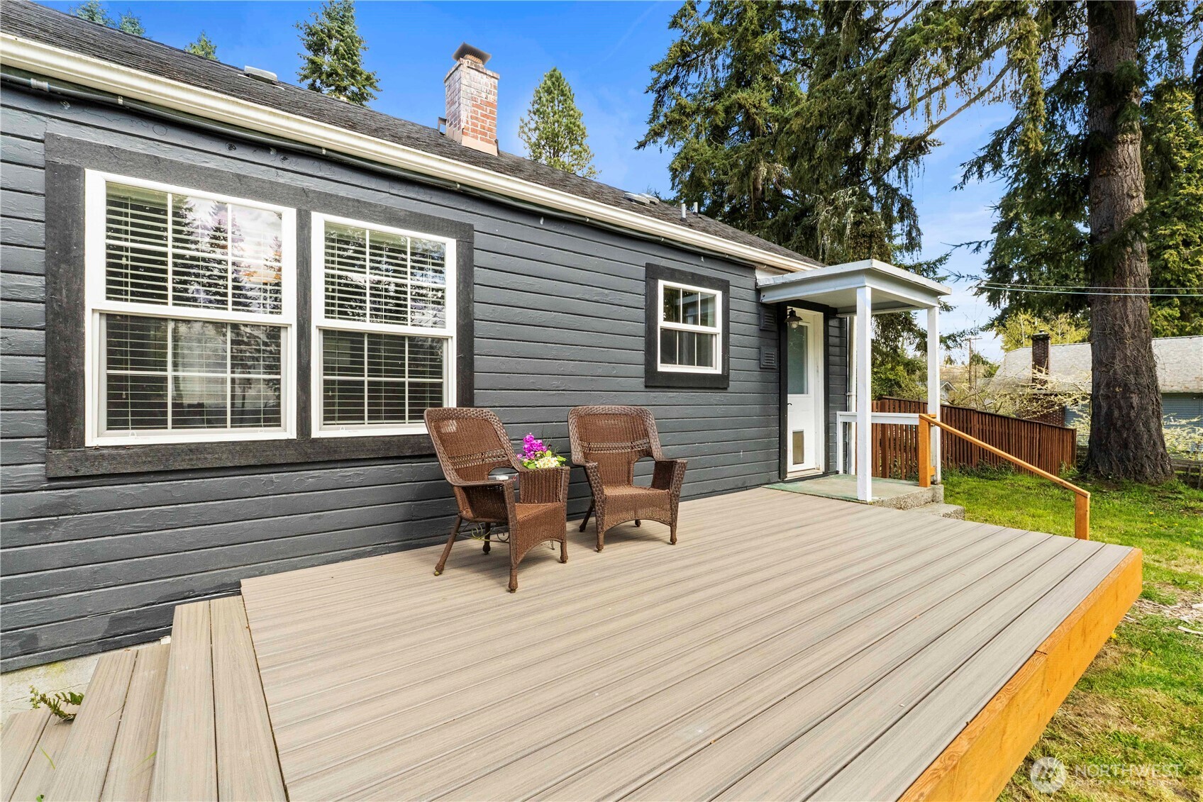 11716 48th Street East Edgewood, WA 98372 - Photo 20 of 29 a view of a deck with table and chairs with wooden floor and fence