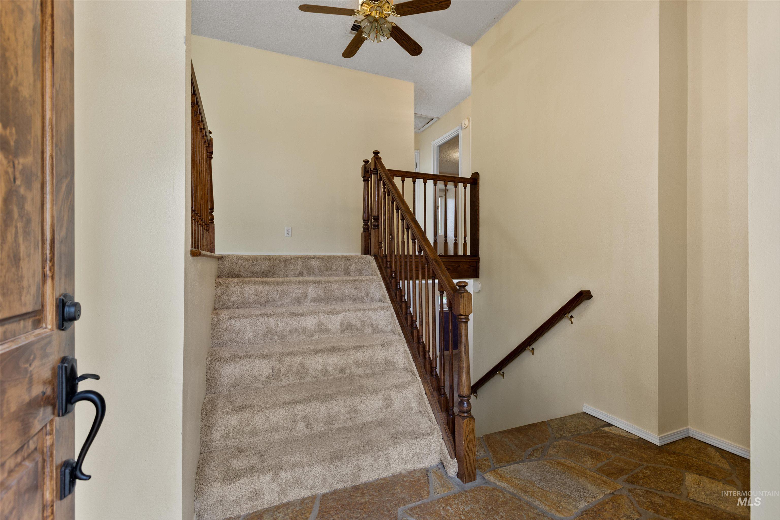 9948 Ash Lane Payette, ID 83661 - Photo 17 of 34 Staircase featuring stone tile flooring and a ceiling fan