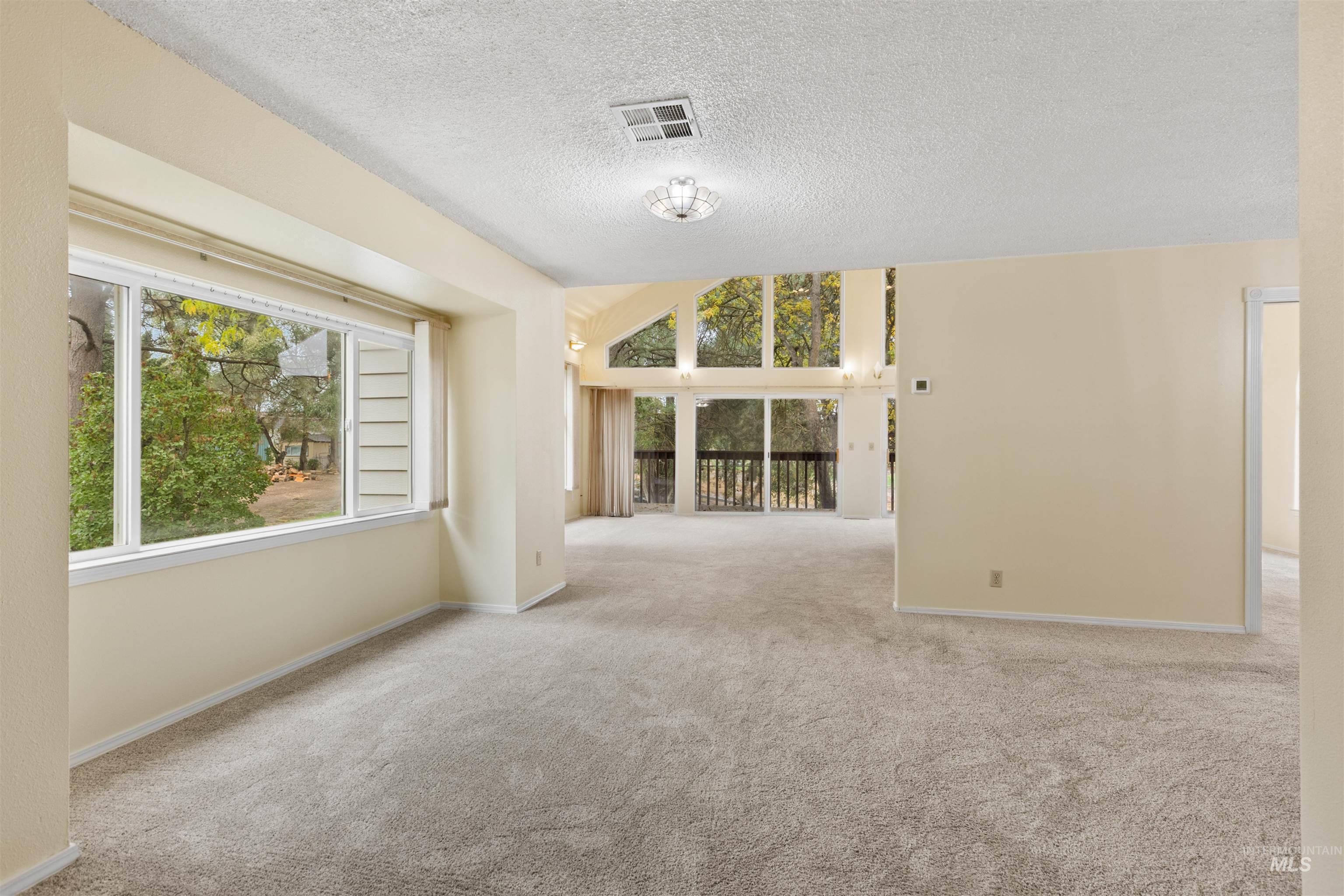 9948 Ash Lane Payette, ID 83661 - Photo 7 of 34 Spare room featuring light colored carpet and a textured ceiling