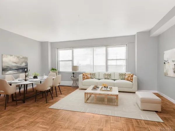 a living room with furniture and large windows
