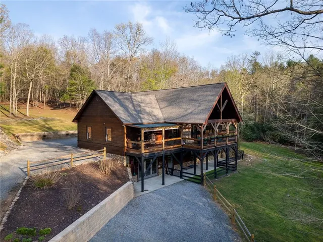 a view of a house with backyard porch and sitting area