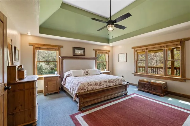 a bedroom with a bed wooden floor and window