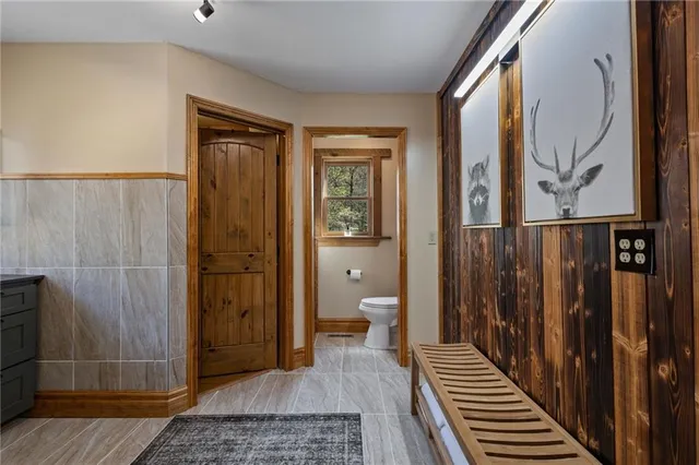 a bedroom with a large bed and a chandelier