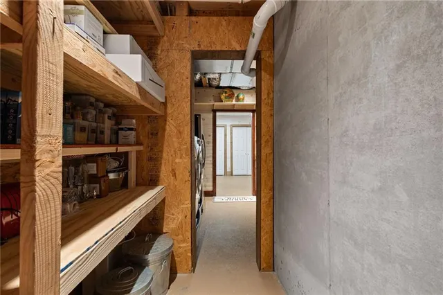 a view of a wooden chairs and table in the back yard