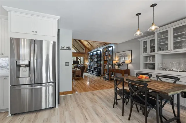 a very nice looking dining room with kitchen island hardwood floor and a refrigerator