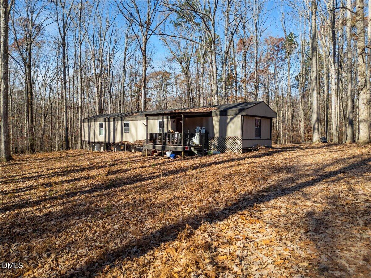 407 Mountain Brook Road Rougemont, NC 27572 - Photo 19 of 23 a front view of a building with large trees