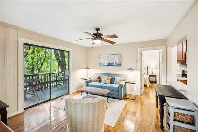 a living room with furniture and a large window with wooden floor