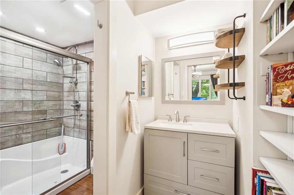 116 Sconti Ridge, Unit 419B Jasper, GA 30143 - Photo 15 of 17 a bathroom with a tub sink and mirror