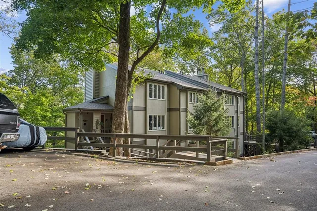 a view of a house with a large window and wooden fence