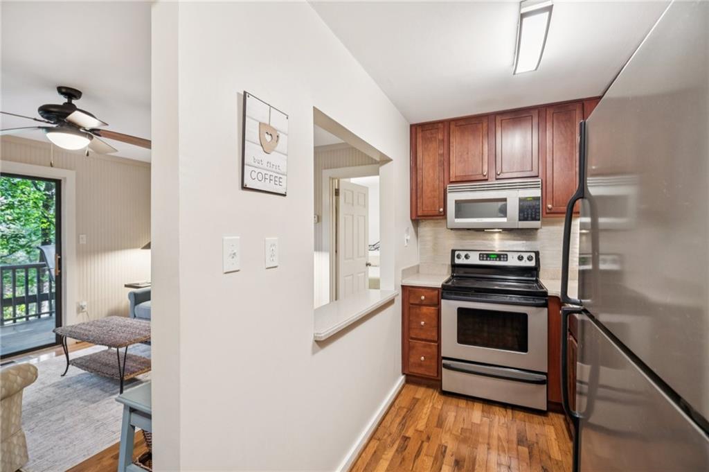 116 Sconti Ridge, Unit 419B Jasper, GA 30143 - Photo 6 of 17 a kitchen with stainless steel appliances a stove a microwave and a hard wood floors
