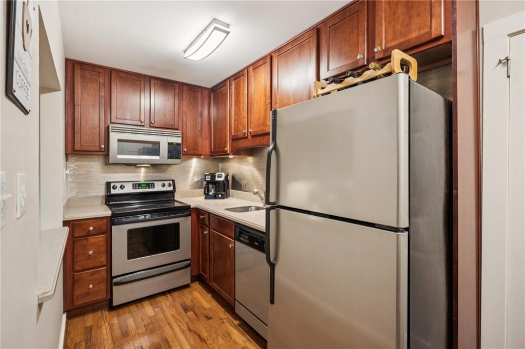 116 Sconti Ridge, Unit 419B Jasper, GA 30143 - Photo 7 of 17 a white refrigerator freezer and a stove sitting inside of a kitchen