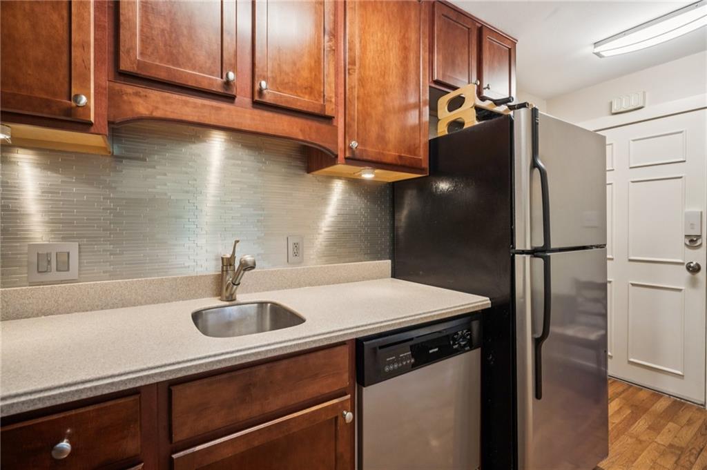 116 Sconti Ridge, Unit 419B Jasper, GA 30143 - Photo 8 of 17 a kitchen with stainless steel appliances granite countertop a a sink and a refrigerator