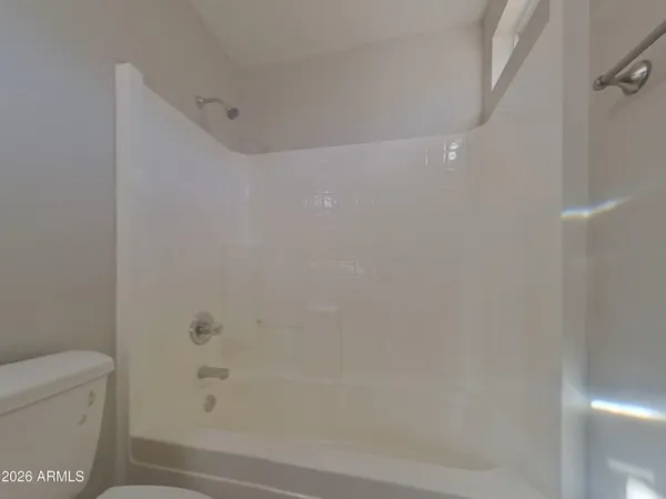 a bathroom with a sink a toilet a mirror and shower