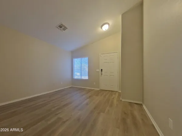 a view of a room with wooden floor