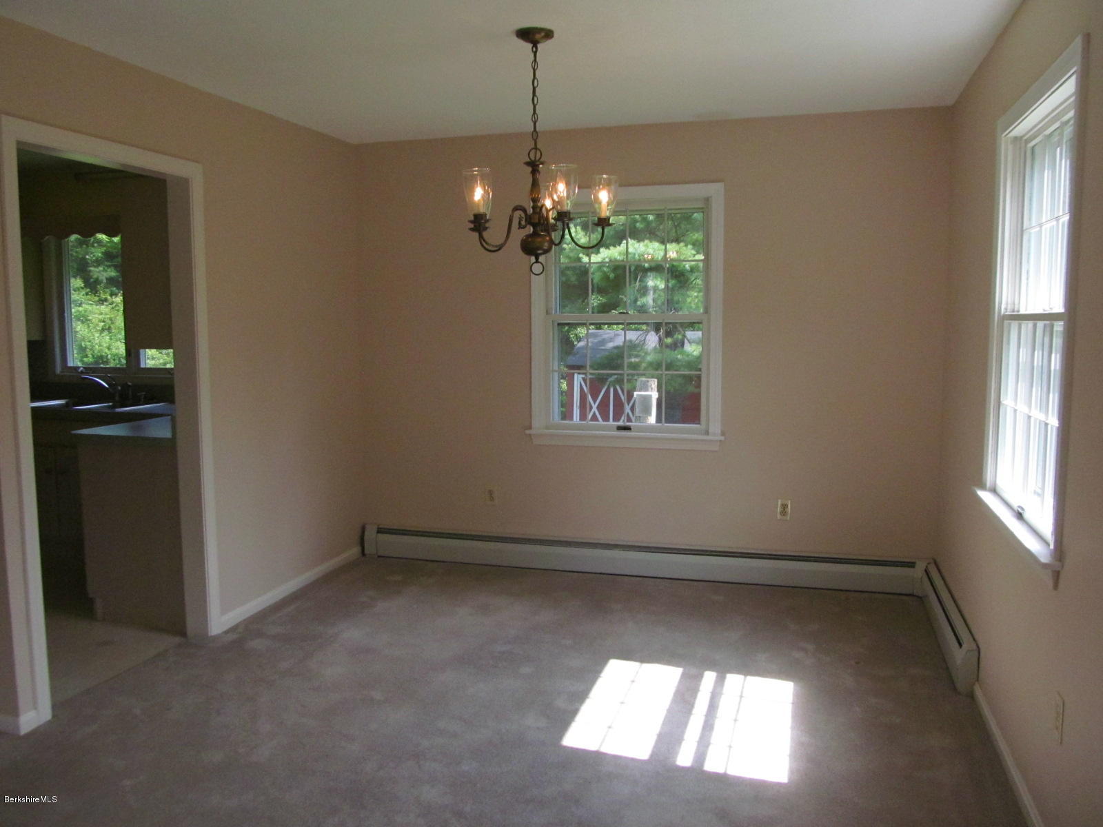 898 Shaw Road Windsor, MA 01270 - Photo 8 of 34 en empty room with windows and chandelier