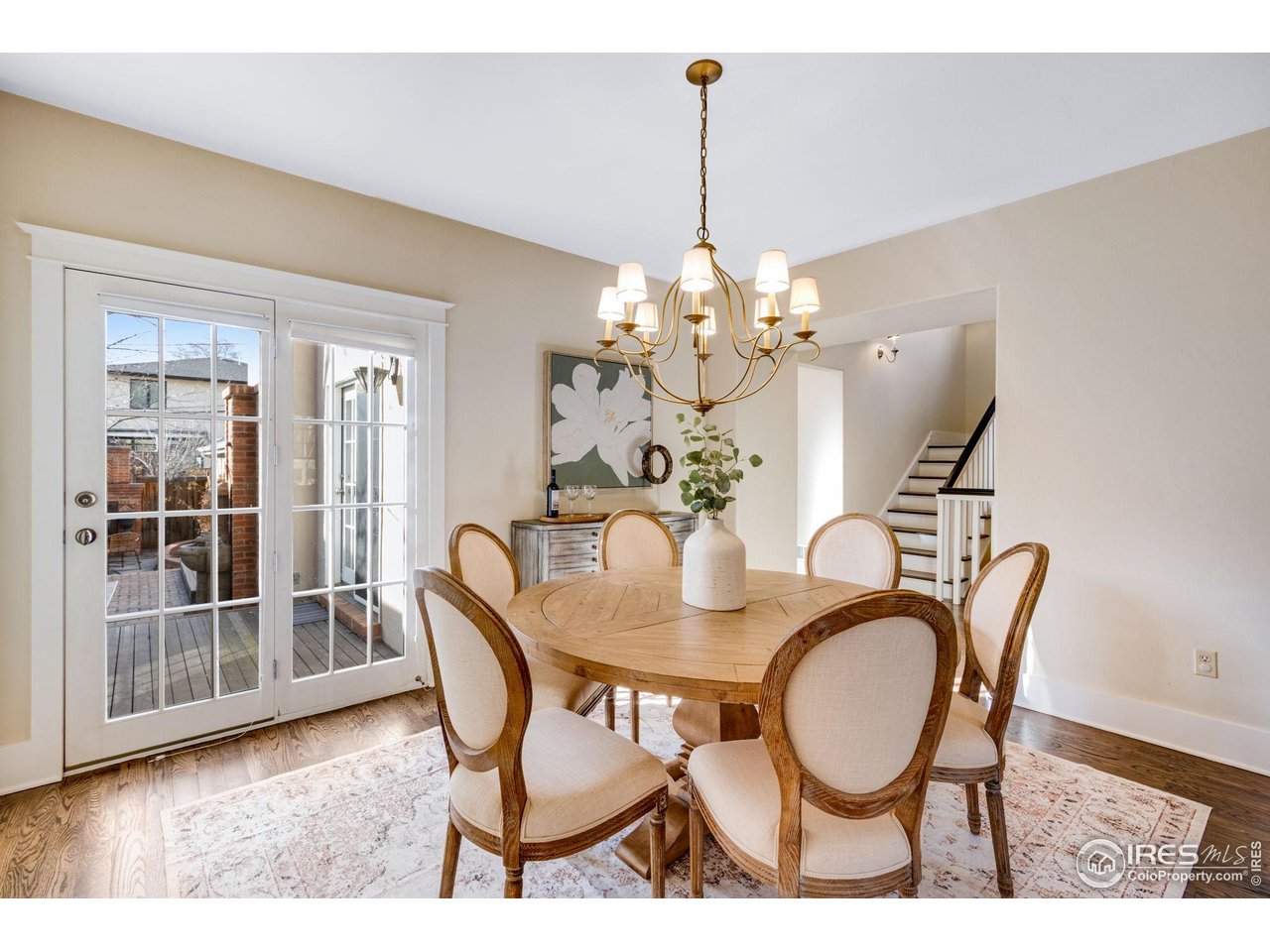 707 South Fillmore Street Denver, CO 80209 - Photo 20 of 47 a dining room with furniture a chandelier and wooden floor