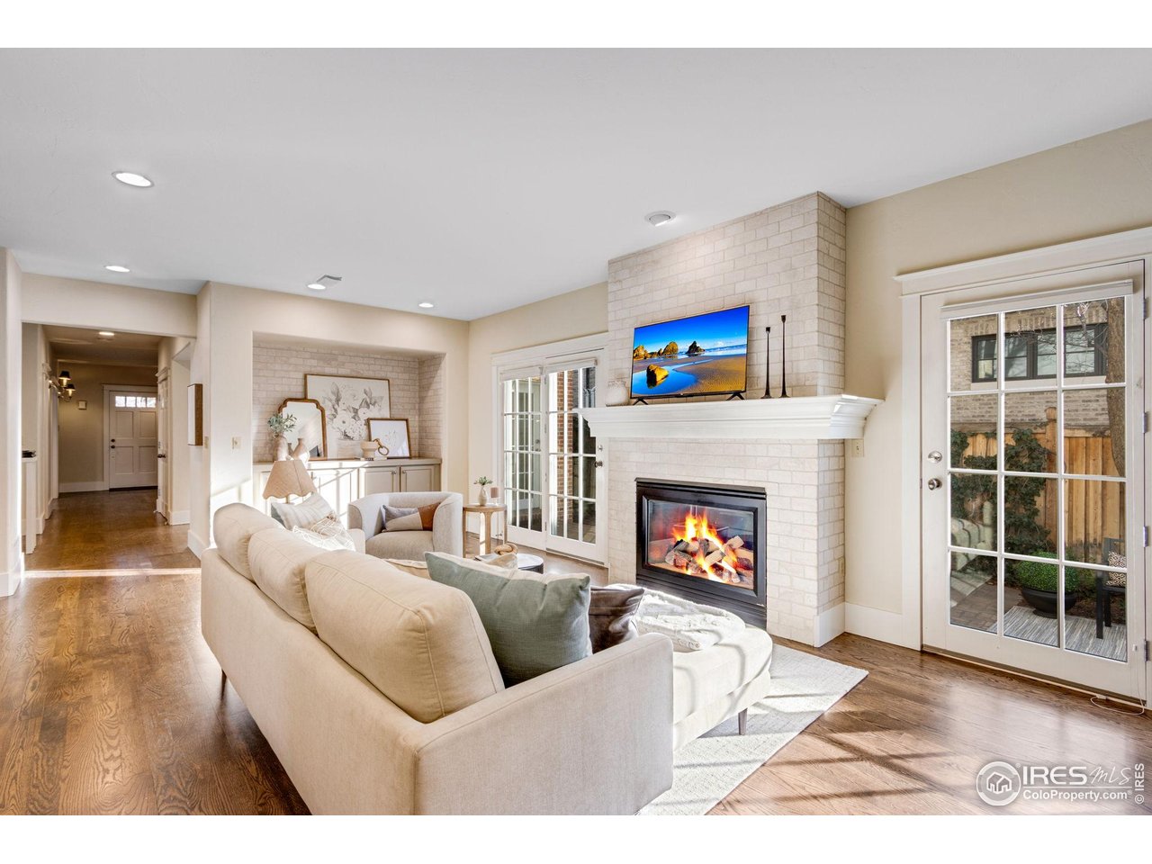 707 South Fillmore Street Denver, CO 80209 - Photo 24 of 47 a living room with furniture a fireplace and a floor to ceiling window