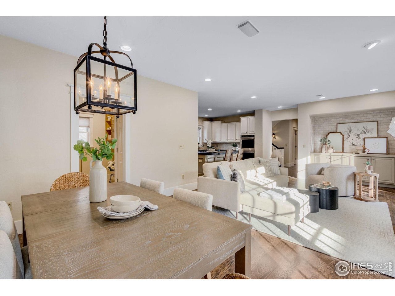 707 South Fillmore Street Denver, CO 80209 - Photo 27 of 47 a view of a dining room and livingroom with furniture wooden floor a chandelier