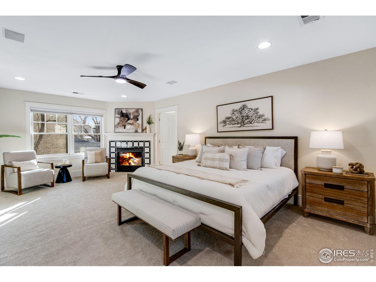 707 South Fillmore Street Denver, CO 80209 - Photo 30 of 47 a spacious bedroom with a bed a couch and a window
