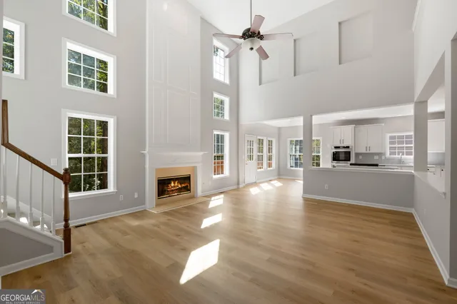 a view of a livingroom with wooden floor and a fireplace