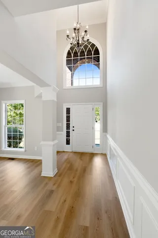 a view of a room with a window and wooden floor