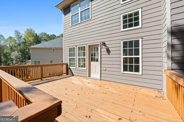 a view of a deck with wooden floor and fence