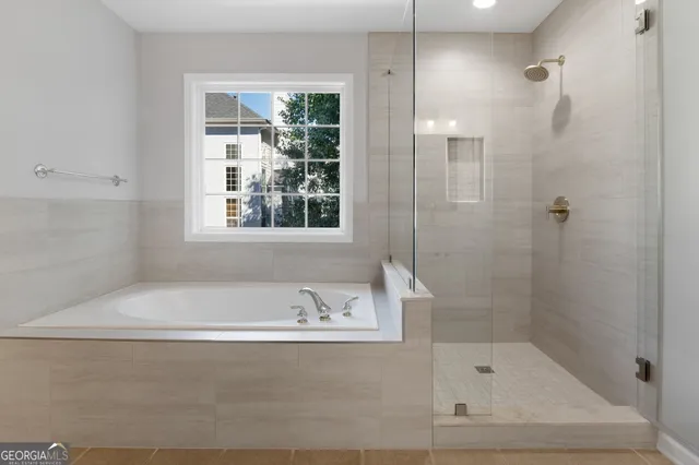 a white bath tub sitting next to a shower