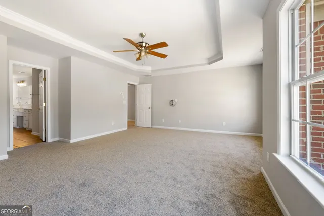 a view of a livingroom with a ceiling fan and window