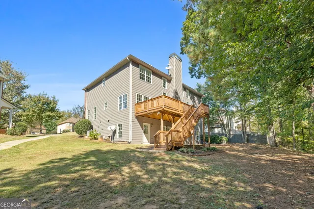 a view of a house with a yard and sitting area