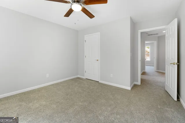 wooden floor in an empty room and a bathroom