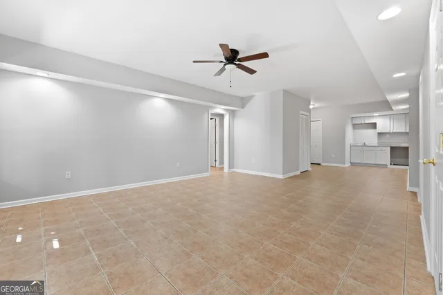 a view of a livingroom with a ceiling fan and window