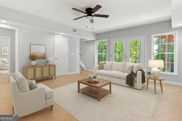 a living room with furniture and a large window