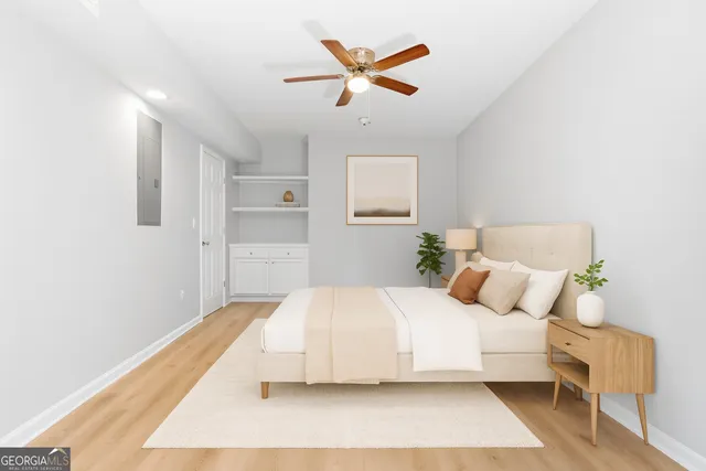 a bedroom with a bed and a ceiling fan
