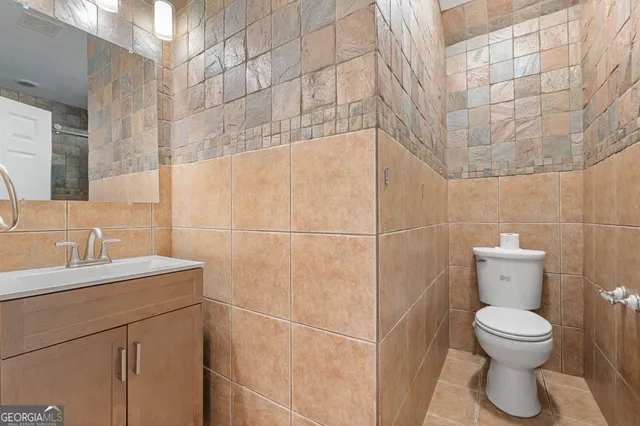 a white toilet sitting next to a bathroom sink