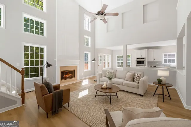 a living room with furniture a fireplace and a table