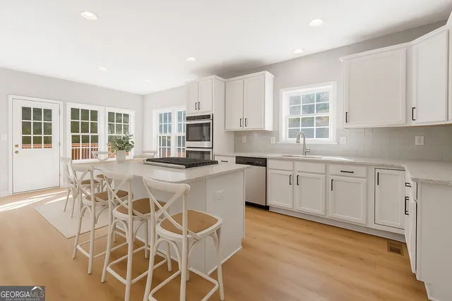 a kitchen with cabinets a sink and appliances