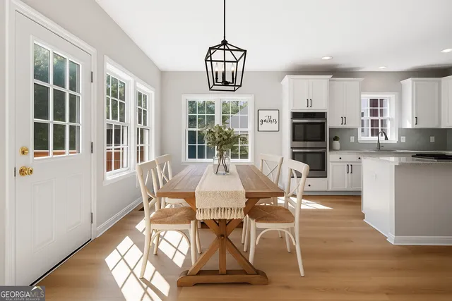 a view of a dining room with furniture window and wooden floor