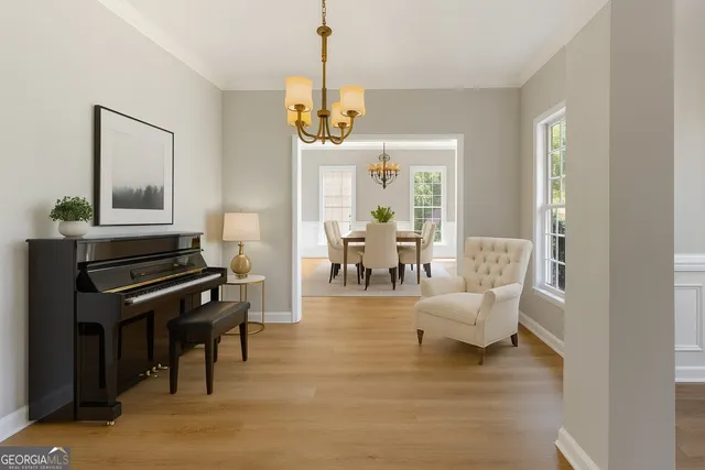 a living room with furniture and a chandelier