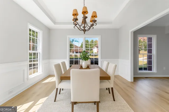 a view of a dining room with furniture window and wooden floor